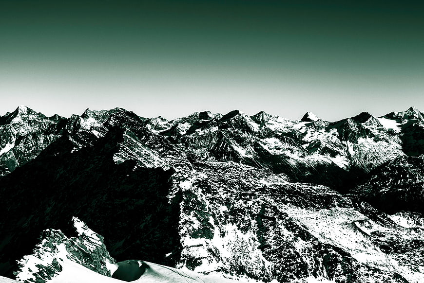 Dramatic High-Contrast Snowy Mountain Range Landscape