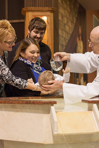 Catholic Baby Baptism Ceremony With Priest And Family