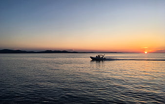 Motorboat Cruising on Calm Sea at Golden Sunset