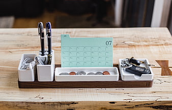 Minimalist wooden desk organizer with calendar, keys, and coins