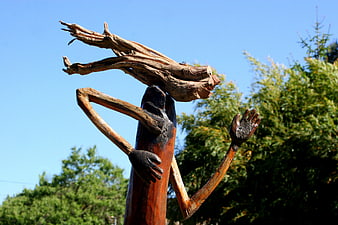 Wooden Sculpture of Figure Carrying Driftwood