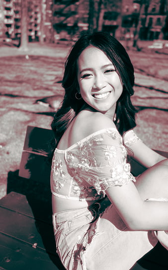 Smiling Woman in Lace Top Sitting Outdoors