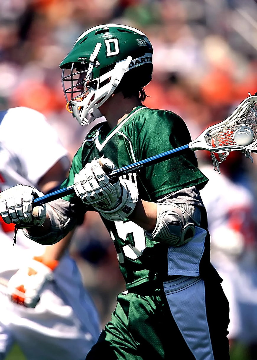 Lacrosse Player in Green Uniform with Stick