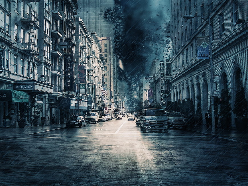 Dramatic city street with dark storm clouds and rain
