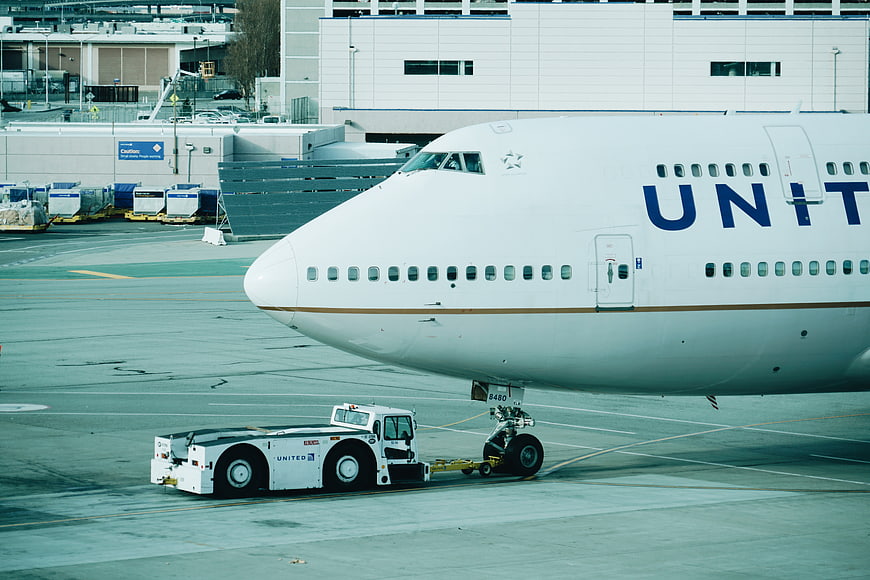 United Airlines Boeing 747 being towed on airport tarmac
