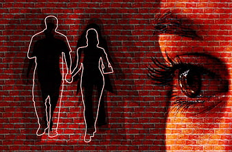 Silhouetted Couple Walking Against Red Brick Wall With Close-Up Eye
