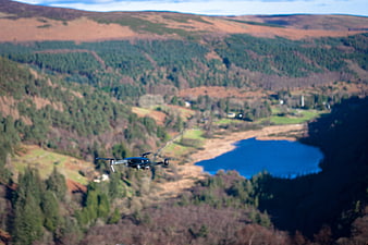 Drone flying over scenic mountain lake and forest landscape