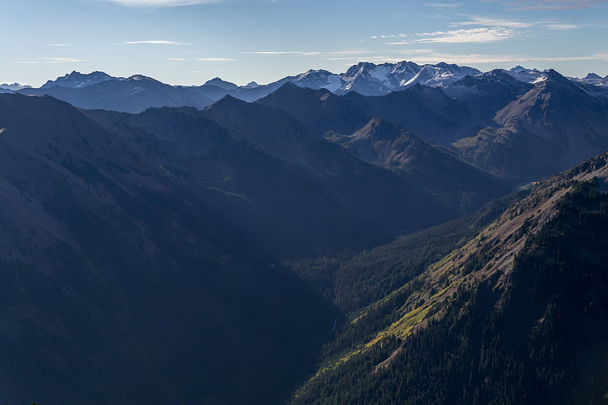 Majestic Mountain Range with Snow-Capped Peaks and Deep Valleys