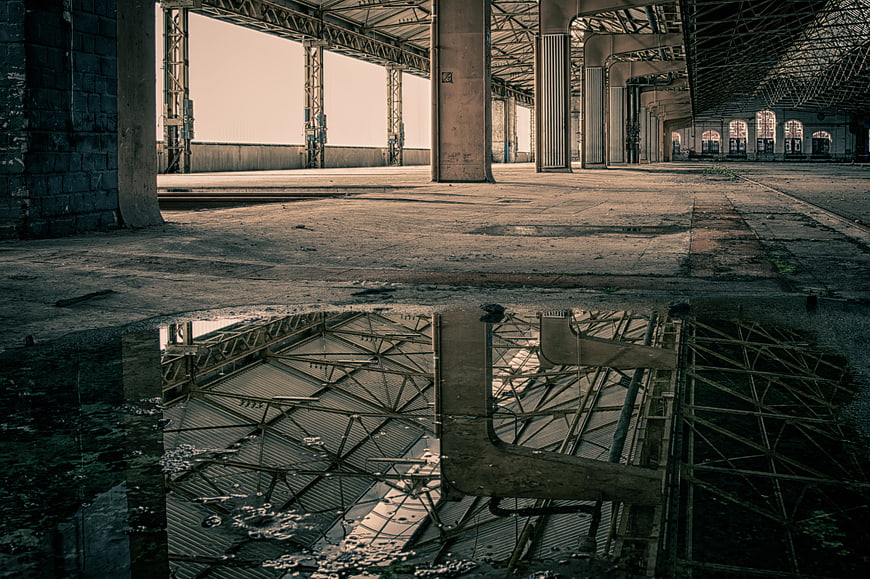 Abandoned Industrial Hall Interior With Water Reflection