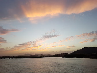 Dramatic Sunset Sky Over River and Cityscape