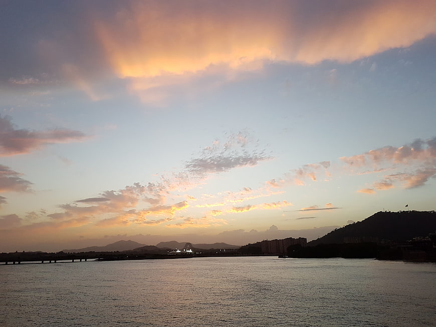 Dramatic Sunset Sky Over River and Cityscape