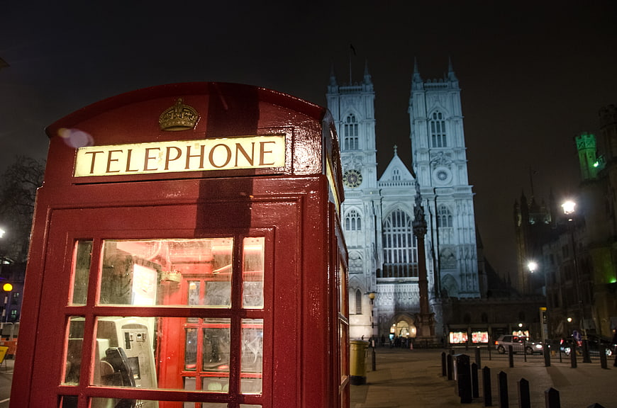 Red Telephone Booth with Westminster Abbey at Night