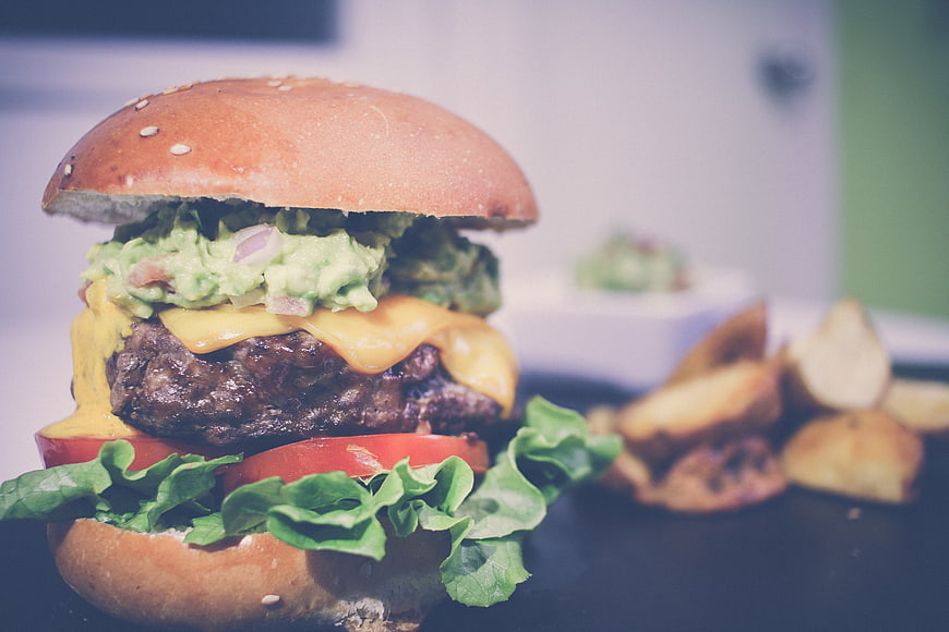 Delicious Gourmet Burger with Guacamole and Cheese