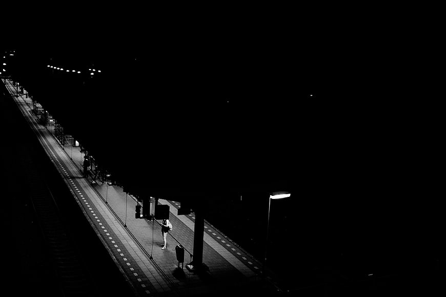 High Contrast Black and White Train Station Platform at Night