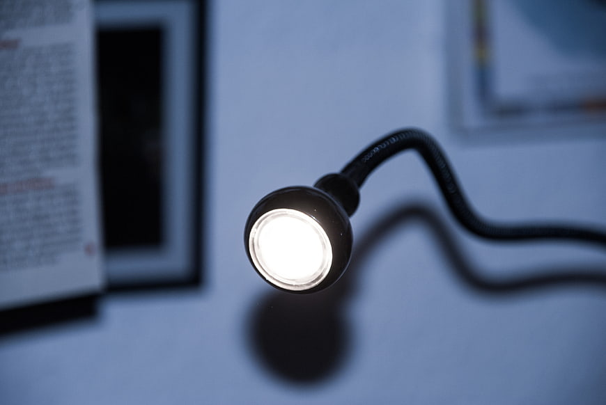 Close-up of flexible LED desk lamp in dim office
