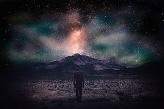 Man Standing Under Milky Way And Aurora Over Mountain