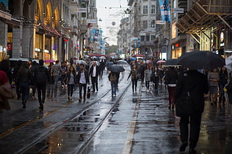 Crowded Istanbul Street with Tram Tracks in Rain