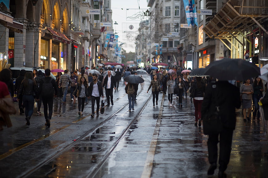 Crowded Istanbul Street with Tram Tracks in Rain