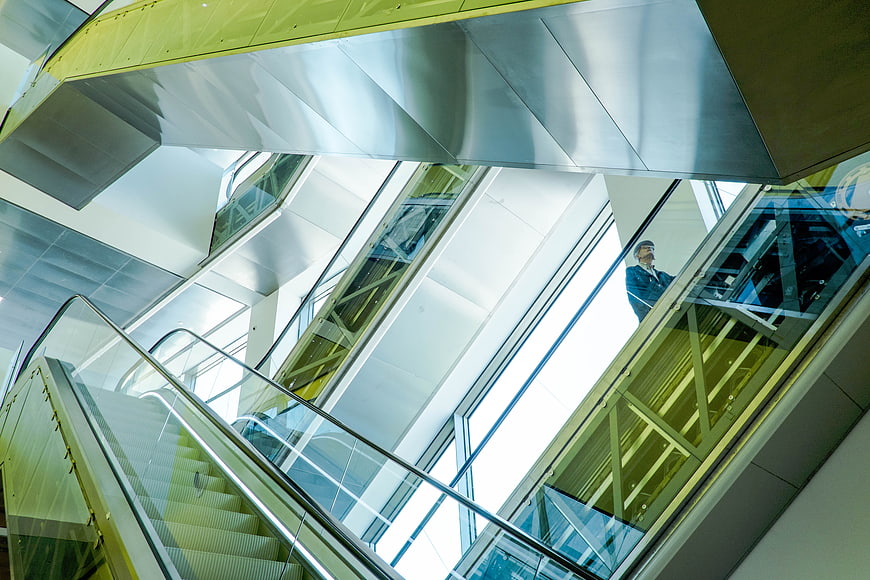 Low angle view of modern escalators in a corporate building interior