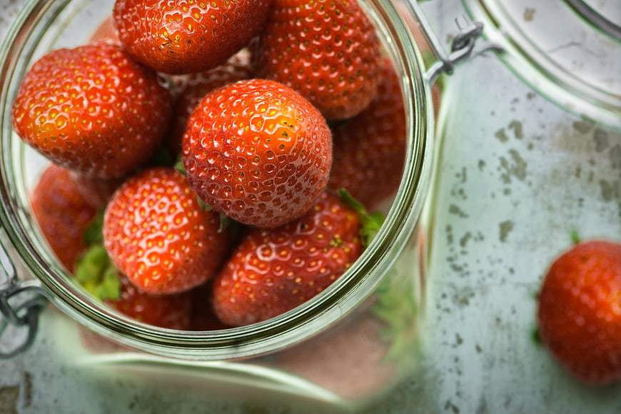 Fresh Red Strawberries in Glass Jar Top View