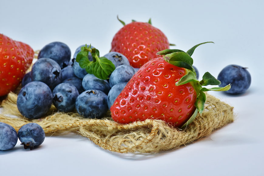 Fresh Strawberries and Blueberries on Burlap