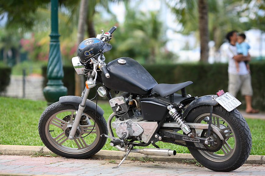 Black Custom Mini Motorcycle Parked On Paved Path