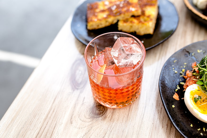 Gin and Tonic with Brunch Food on Wooden Table
