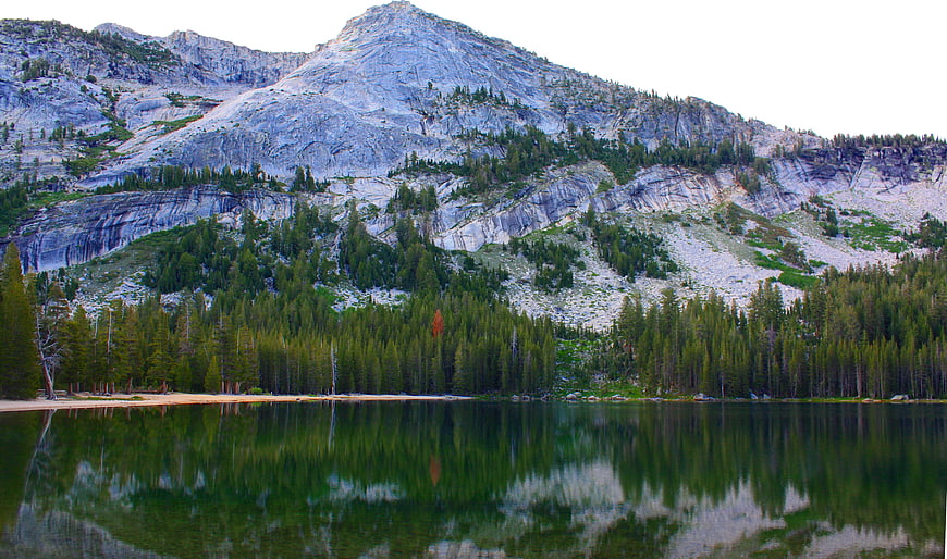 Serene Mountain Lake with Granite Peak and Pine Forest Reflection