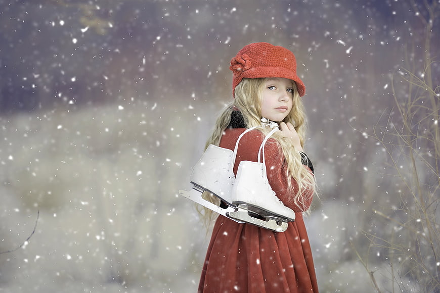 Young Girl in Red Coat Holding Ice Skates in Snow