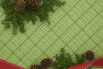 Christmas plaid background with pine branches and red ribbon