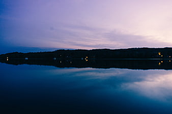 Serene Lake Reflection at Dusk with Purple Sky