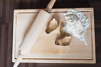 Wooden Rolling Pin and Foot Cookie Cutters on Cutting Board