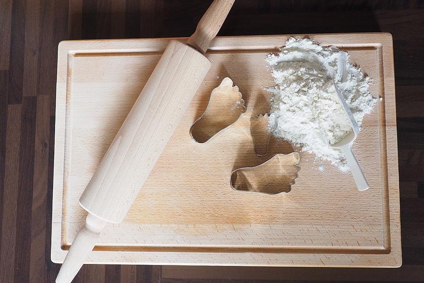 Wooden Rolling Pin and Foot Cookie Cutters on Cutting Board