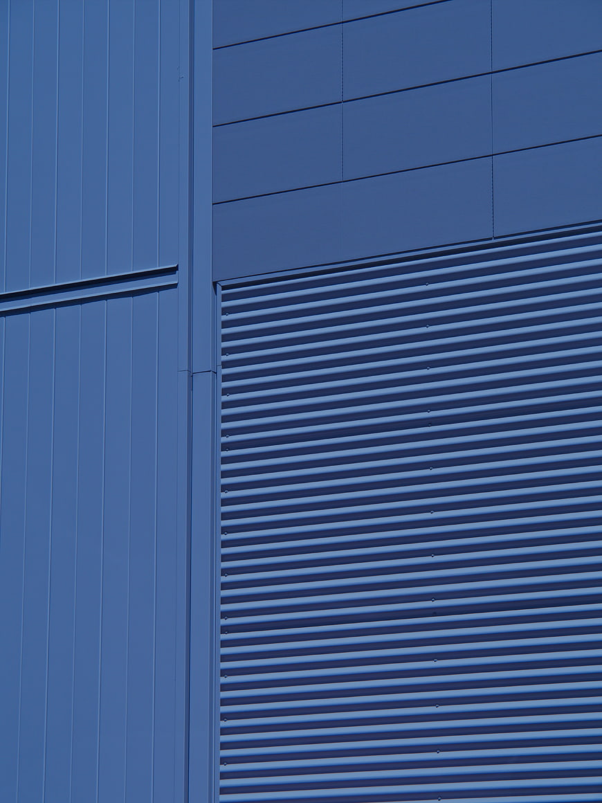 Abstract Blue Industrial Building Facade with Corrugated Metal