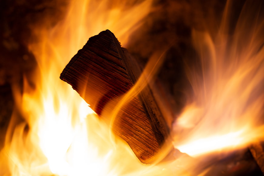 Close-up of burning firewood with bright orange flames