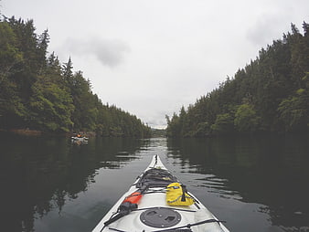 First-person view of white kayak on calm lake