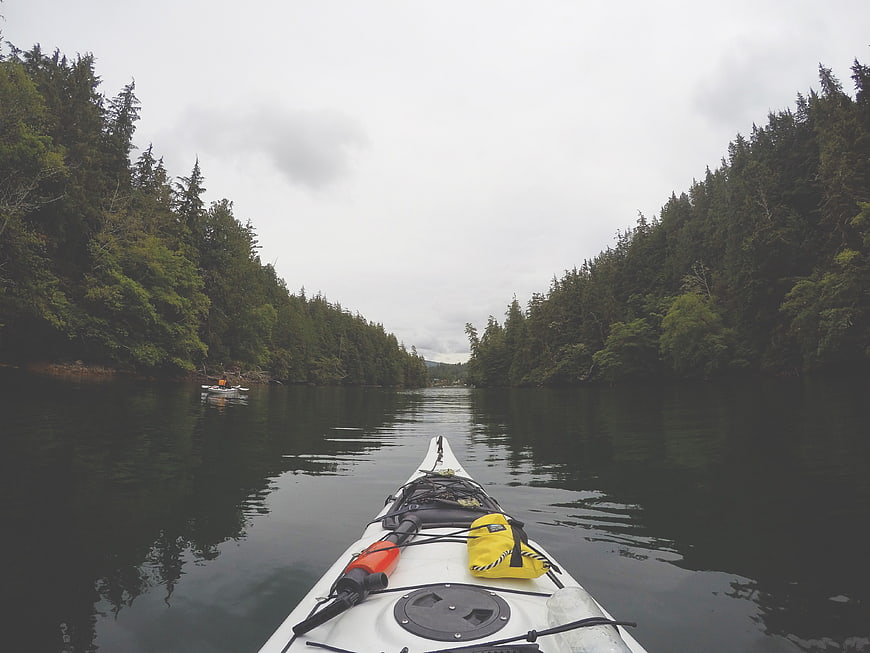 First-person view of white kayak on calm lake