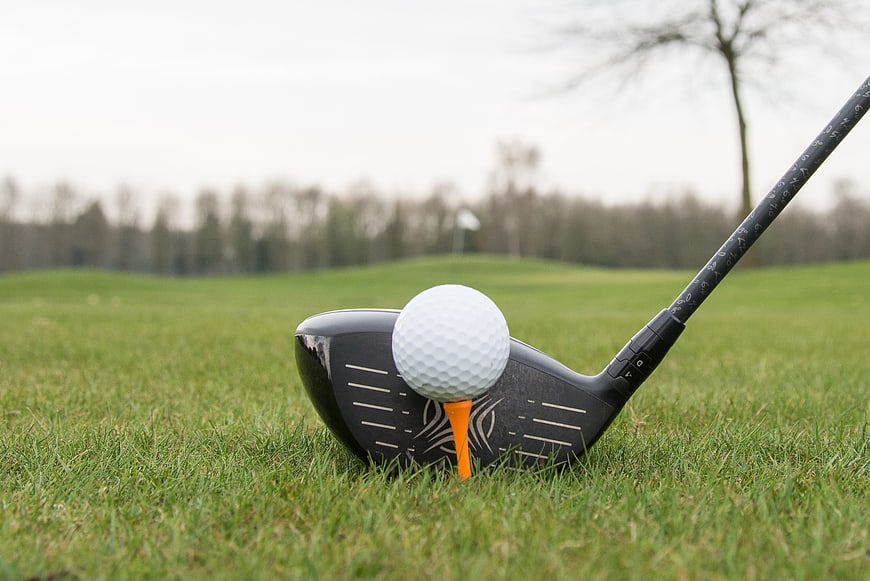 Golf driver and ball on tee ready for drive
