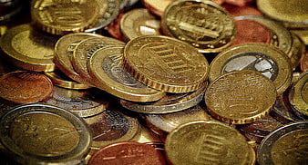 Close-up of scattered euro coins in gold and silver tones
