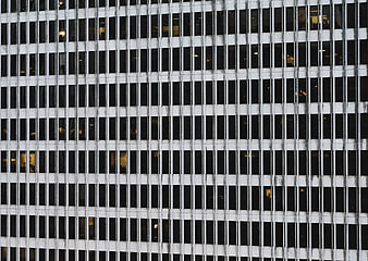 Abstract grid pattern of modern office building facade at night