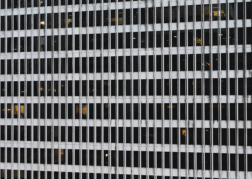 Abstract grid pattern of modern office building facade at night