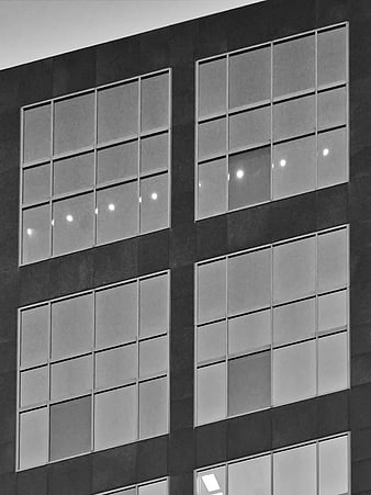 Black and white modern office building facade with grid windows