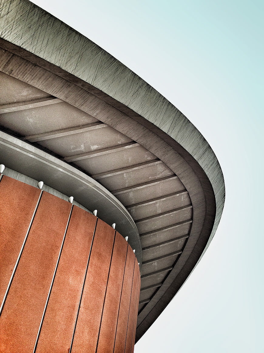 Modern curved concrete and rust-colored architectural detail