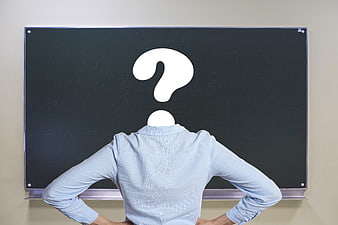 Woman with Question Mark Head in Front of Blackboard
