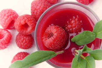 Fresh Raspberry Syrup in Glass Bowl with Sage Leaves