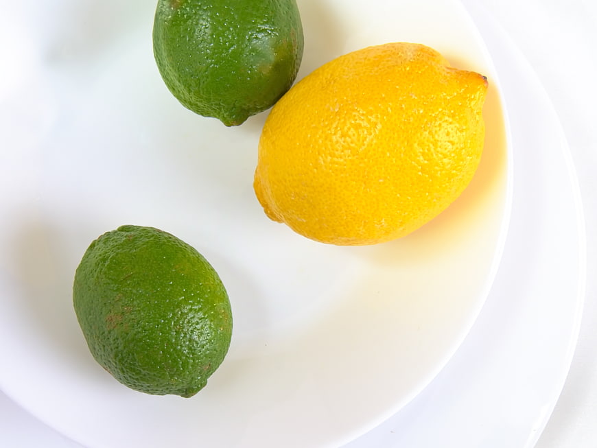 Fresh Lemon and Limes on White Plate