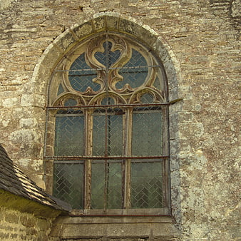 Gothic stone window on old church wall