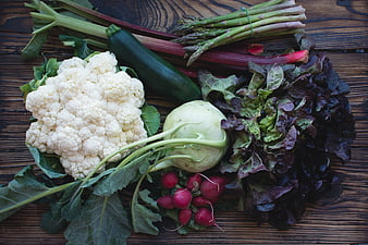 Fresh organic vegetables flat lay on rustic wooden table