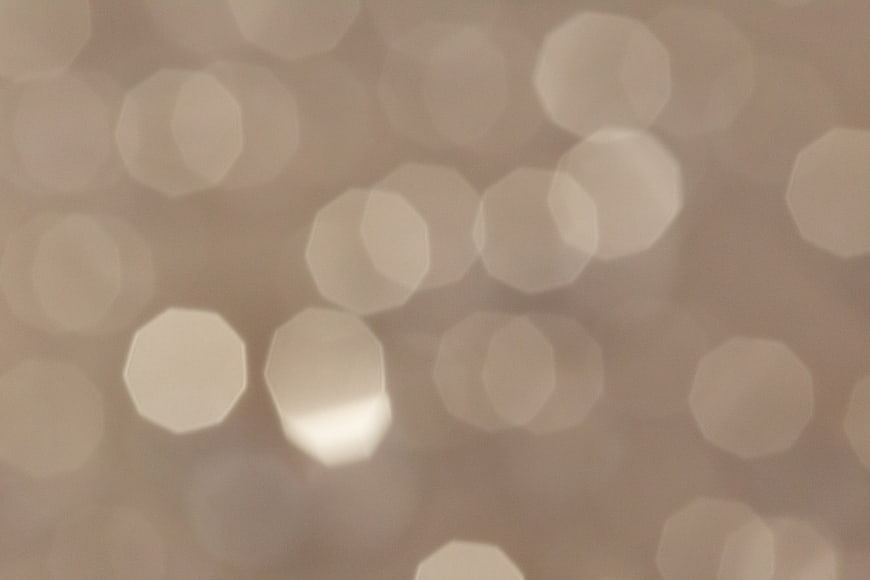 Soft beige bokeh background with abstract light circles