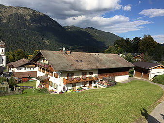 Traditional Alpine Farmhouse with Mountain Backdrop